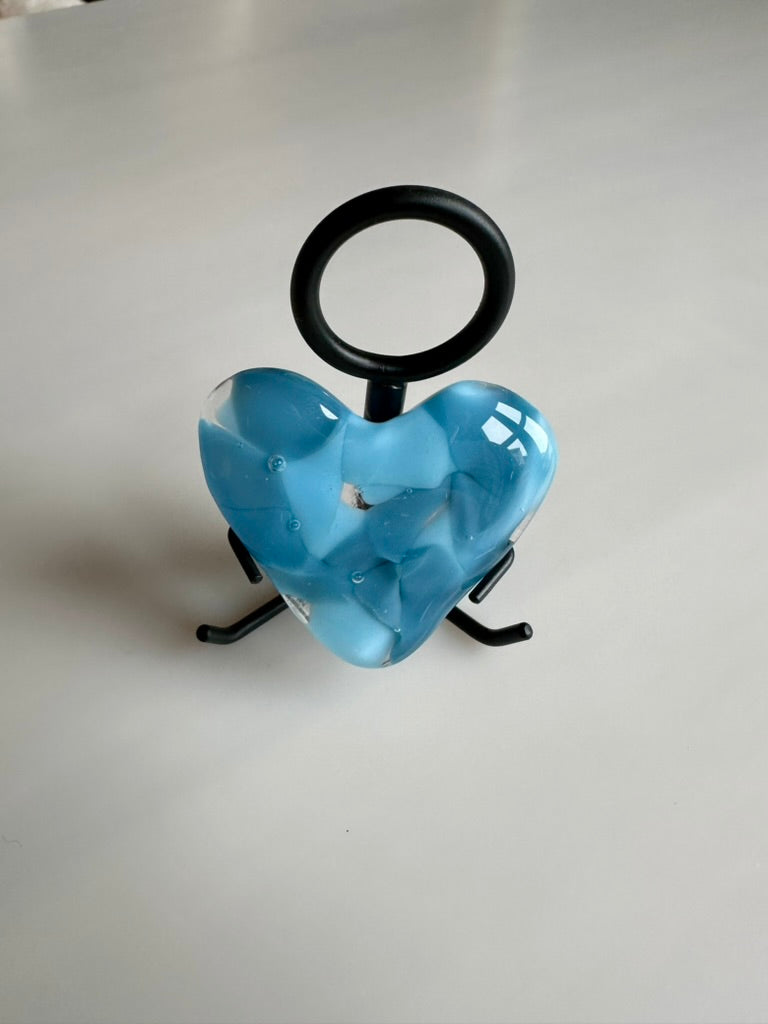 A Metal Person holding a Fused Glass Heart