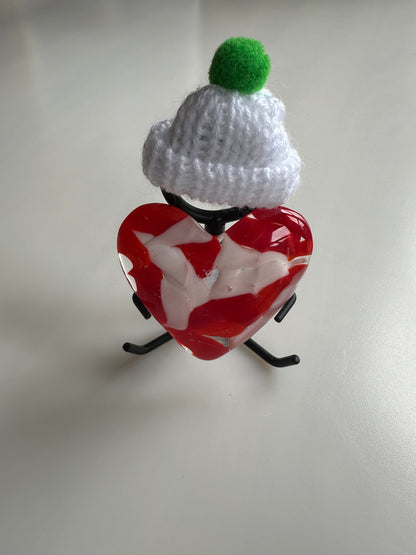 A Metal Person holding a Fused Glass Heart