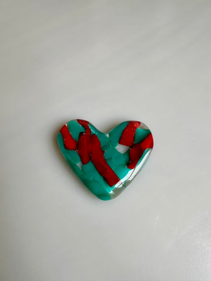 A Metal Person holding a Fused Glass Heart