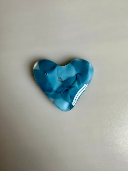 A Metal Person holding a Fused Glass Heart