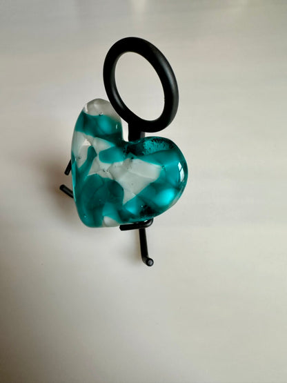 A Metal Person holding a Fused Glass Heart