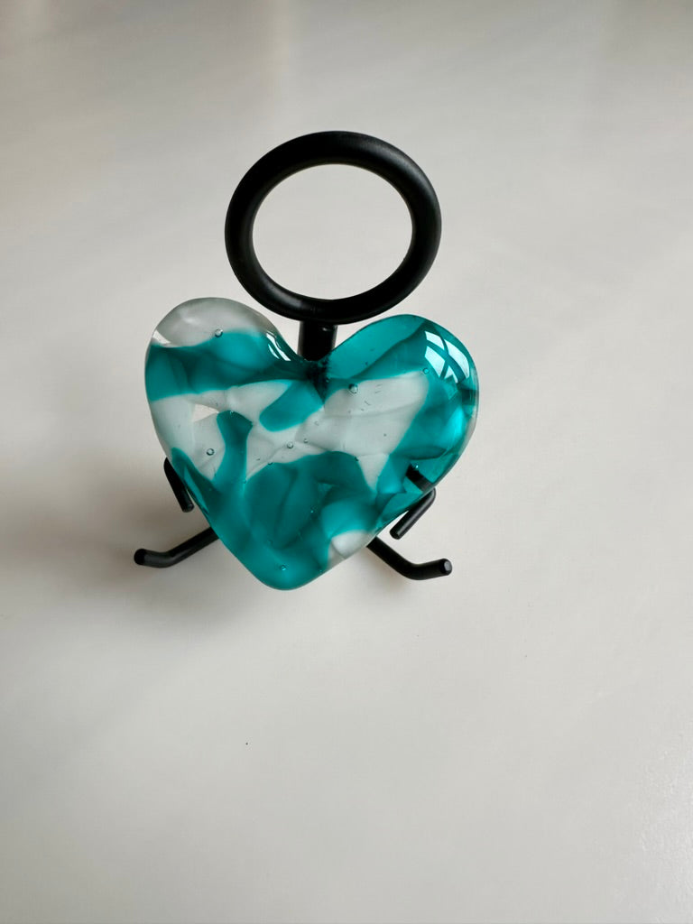 A Metal Person holding a Fused Glass Heart