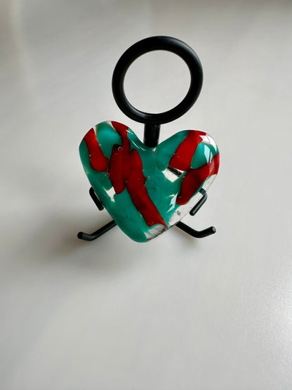 A Metal Person holding a Fused Glass Heart