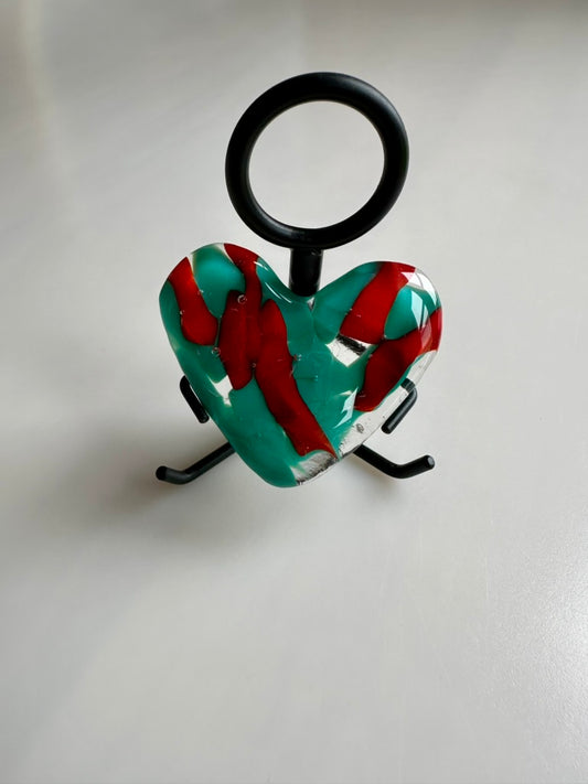 A Metal Person holding a Fused Glass Heart