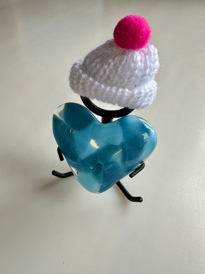 A Metal Person holding a Fused Glass Heart