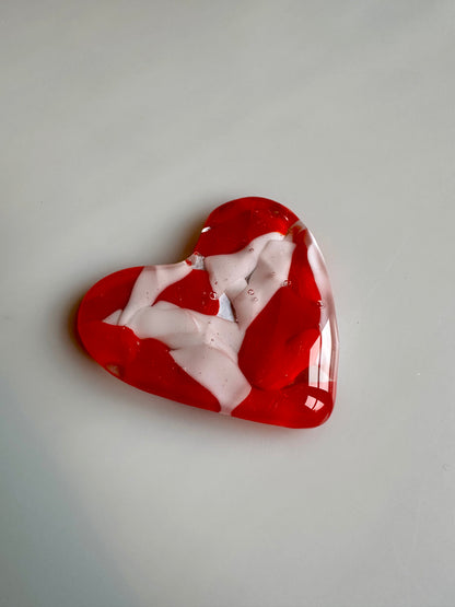 A Metal Person holding a Fused Glass Heart