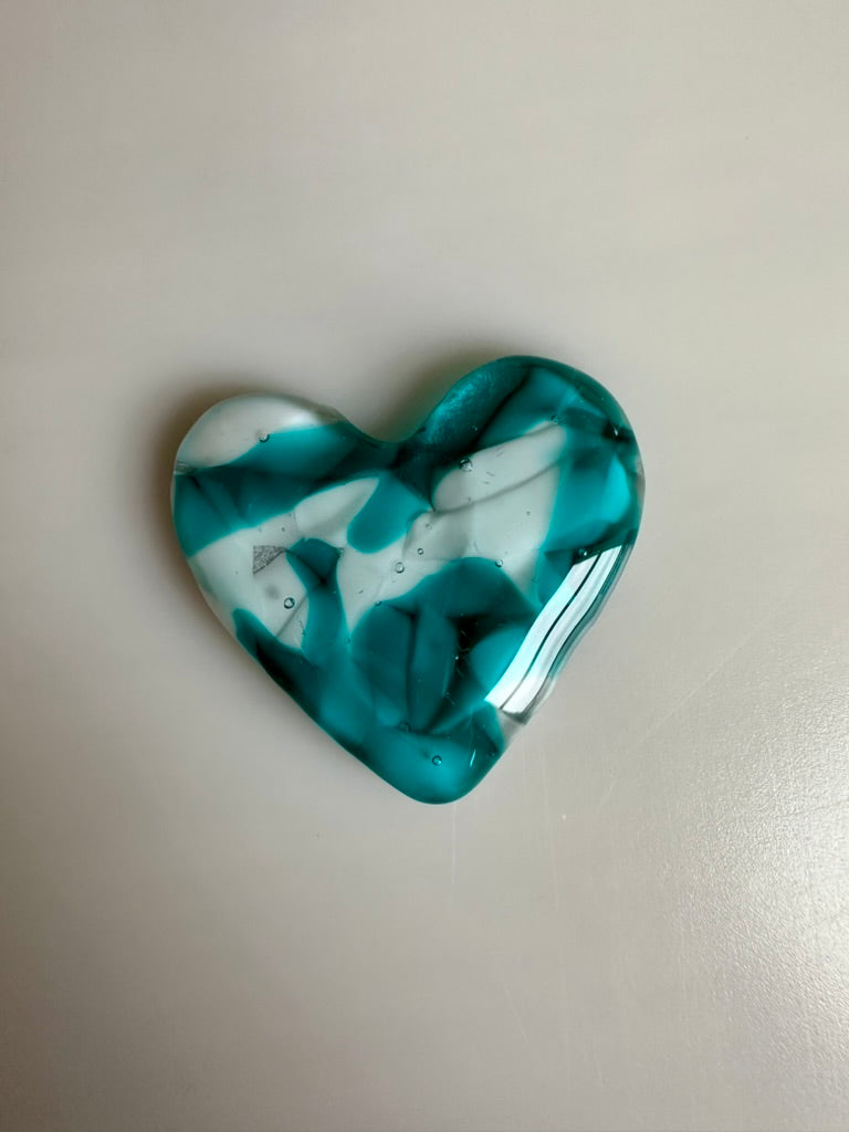 A Metal Person holding a Fused Glass Heart