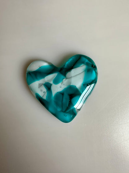 A Metal Person holding a Fused Glass Heart