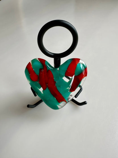 A Metal Person holding a Fused Glass Heart