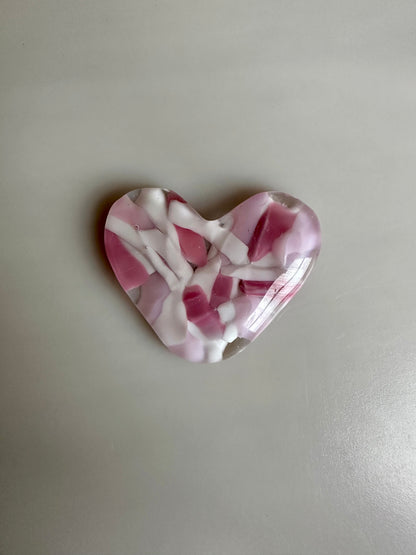 A Metal Person holding a Fused Glass Heart